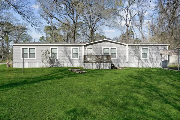 a view of a house with yard and a tree