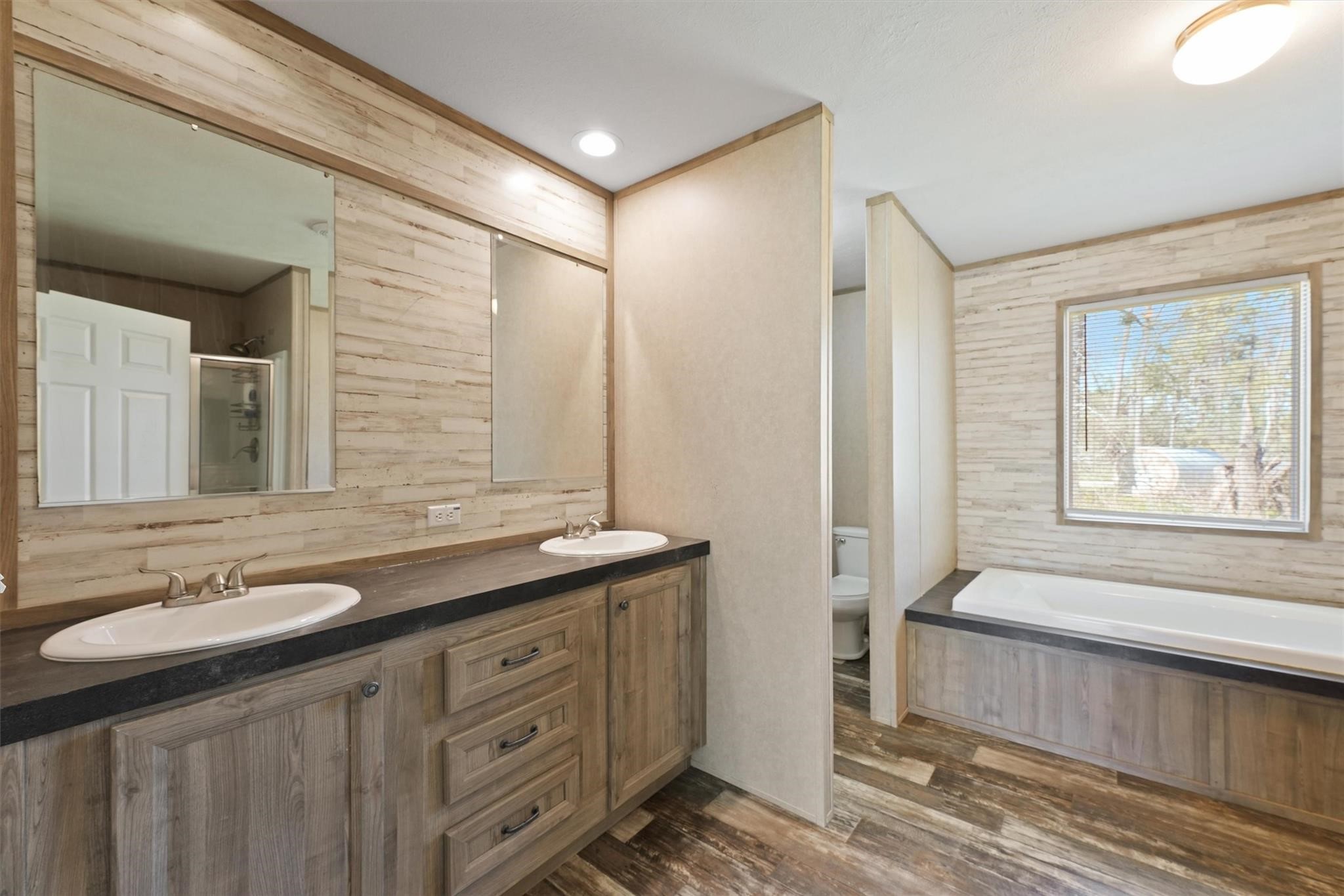 11744 Padok Road Houston, TX 77044 - Photo 12 of 21 a spacious bathroom with a double vanity sink a mirror and a bathtub