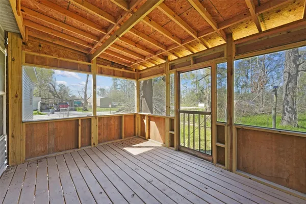 a view of a room with wooden floor and iron stairs