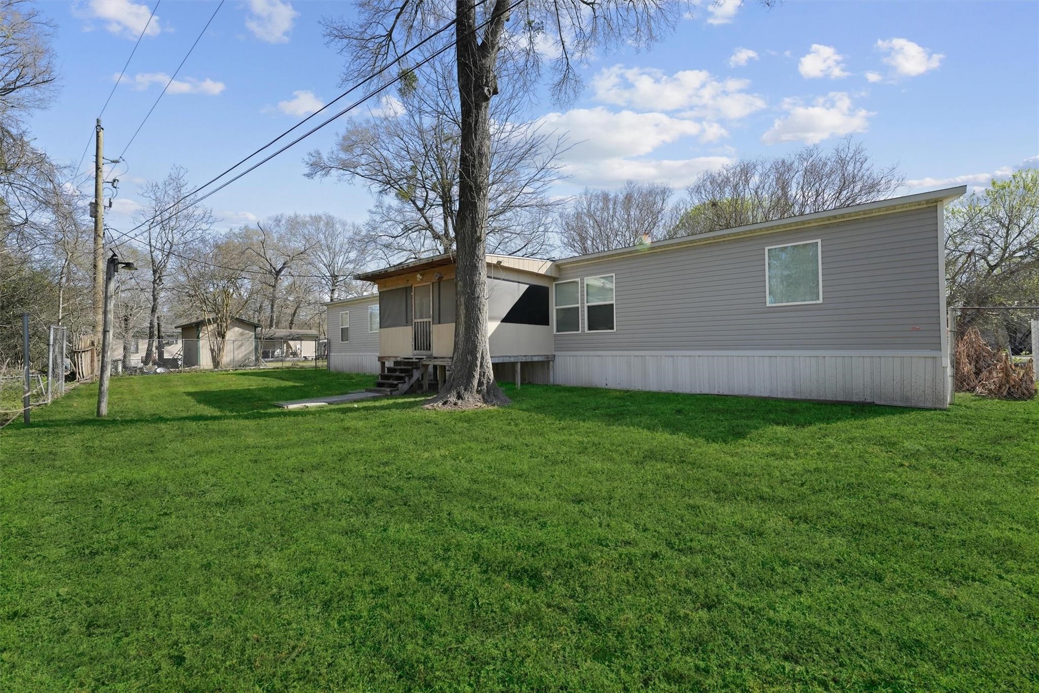 11744 Padok Road Houston, TX 77044 - Photo 19 of 21 a view of a house with yard and a tree