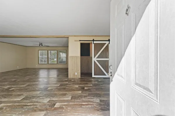 a view of entryway and hall with wooden floor