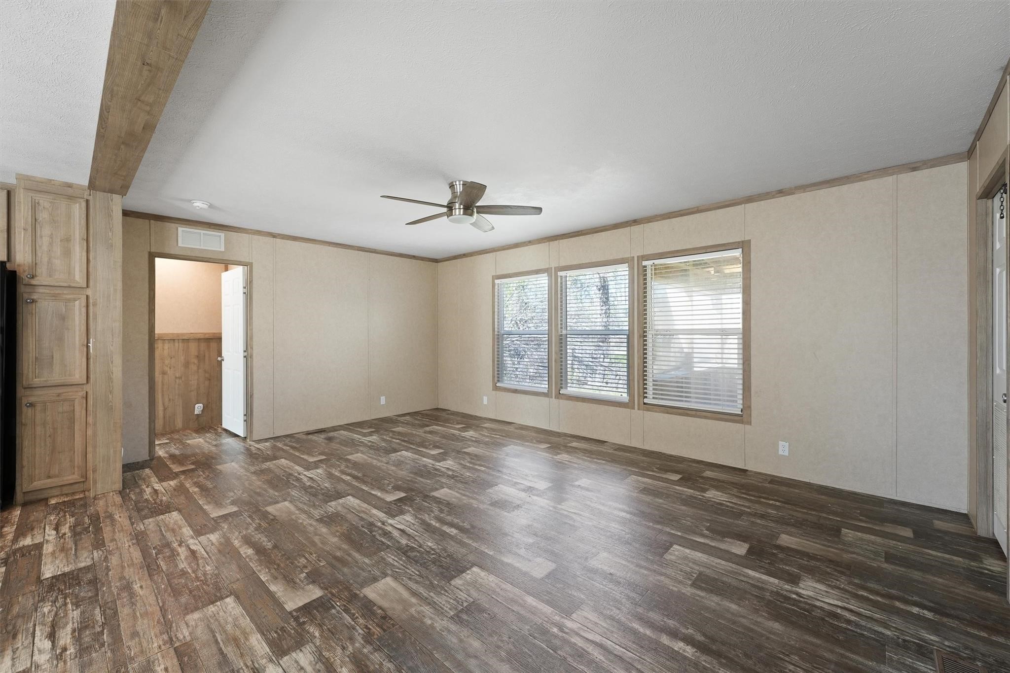 11744 Padok Road Houston, TX 77044 - Photo 7 of 21 a view of an empty room with a window and wooden floor