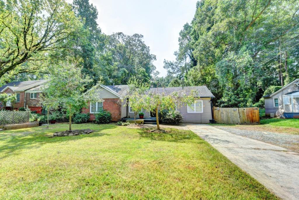 3409 Beech Drive Decatur, GA 30032 - Photo 1 of 1 a house with a big yard and large trees
