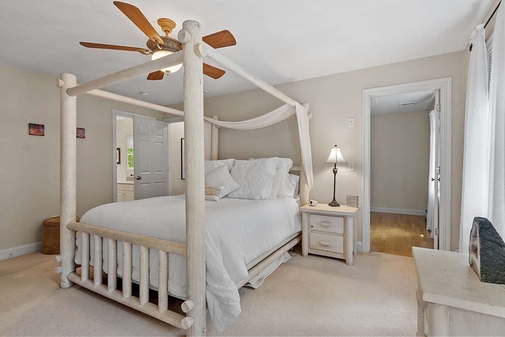 34 Ball Hill Road Princeton, MA 01541 - Photo 17 of 37 a spacious bedroom with a bed and a chandelier