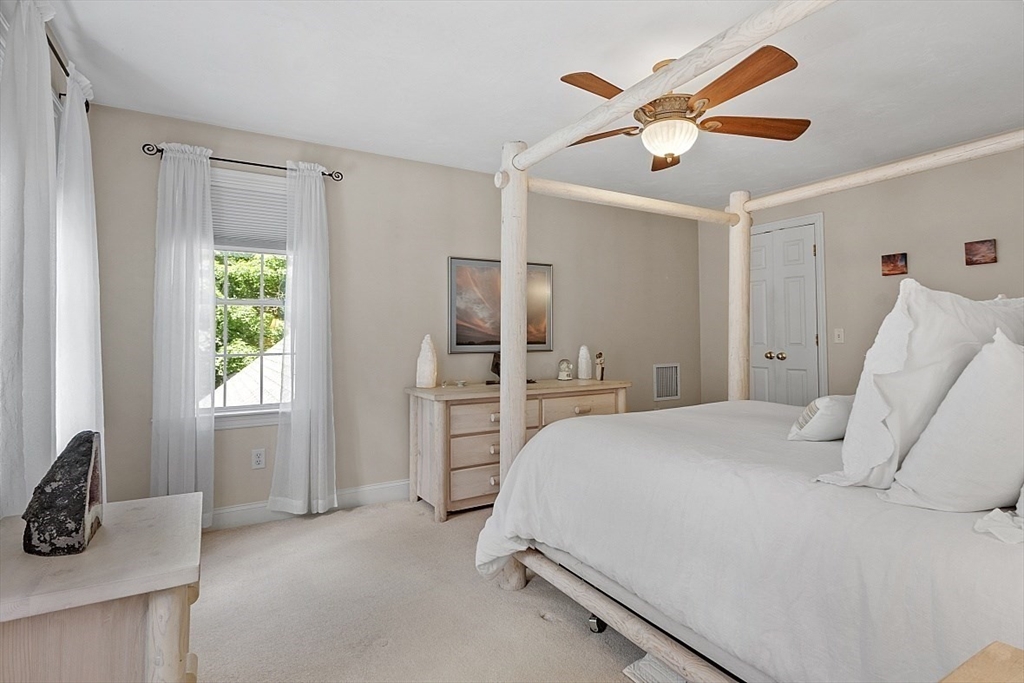 34 Ball Hill Road Princeton, MA 01541 - Photo 18 of 37 a spacious bedroom with a bed and a chandelier