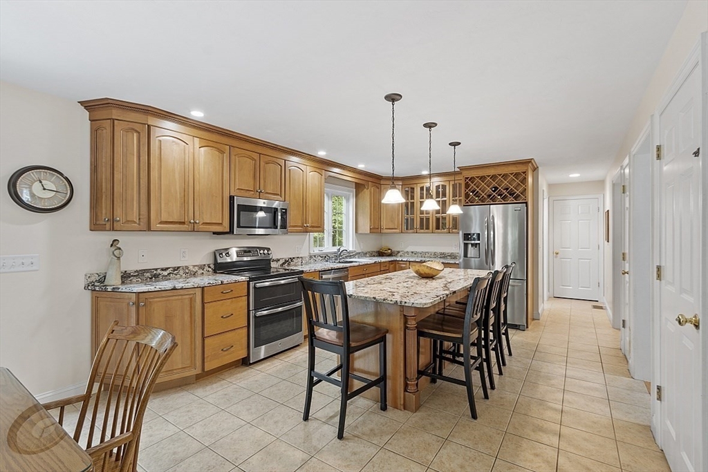 34 Ball Hill Road Princeton, MA 01541 - Photo 8 of 37 a kitchen with stainless steel appliances granite countertop wooden cabinets a stove a sink a dining table and chairs