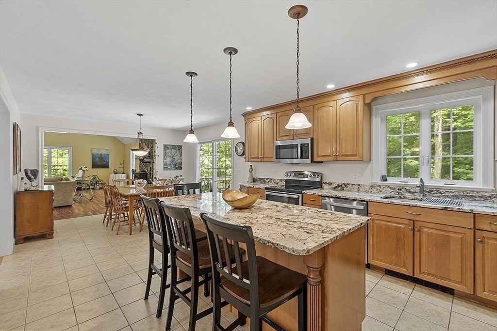34 Ball Hill Road Princeton, MA 01541 - Photo 9 of 37 a open kitchen with a table a sink cabinets and appliances