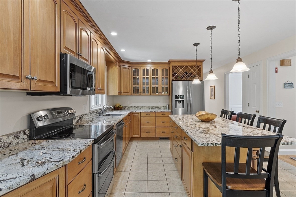 34 Ball Hill Road Princeton, MA 01541 - Photo 10 of 37 a kitchen with a stove a sink a kitchen island with a dining table and chairs