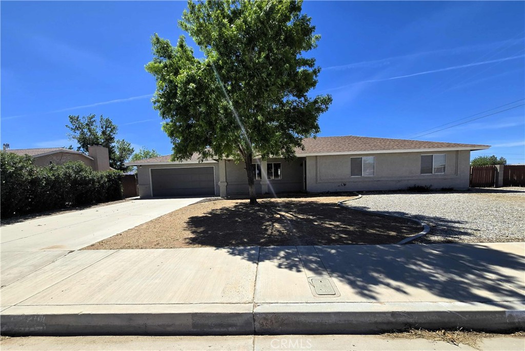 22909 Eyota Road Apple Valley, CA 92308 - Photo 1 of 18 a front view of a house with a yard