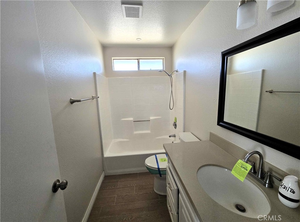 22909 Eyota Road Apple Valley, CA 92308 - Photo 12 of 18 a bathroom with a tub sink and mirror