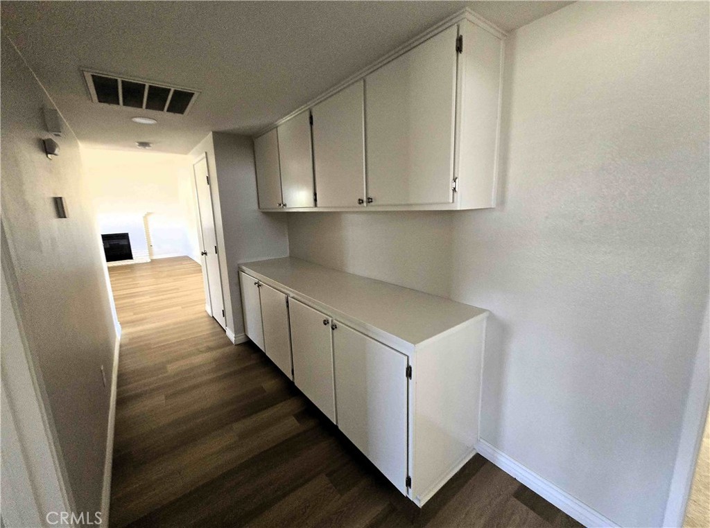 22909 Eyota Road Apple Valley, CA 92308 - Photo 13 of 18 a view of a kitchen with wooden floor and staircase