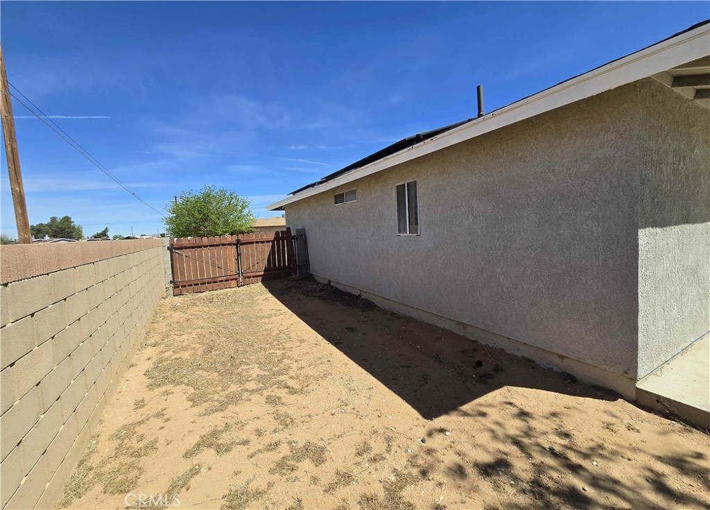 22909 Eyota Road Apple Valley, CA 92308 - Photo 15 of 18 a backyard of a house with a yard