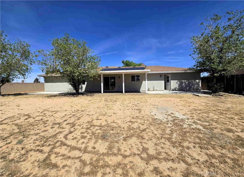 22909 Eyota Road Apple Valley, CA 92308 - Photo 17 of 18 a front view of a house with a yard
