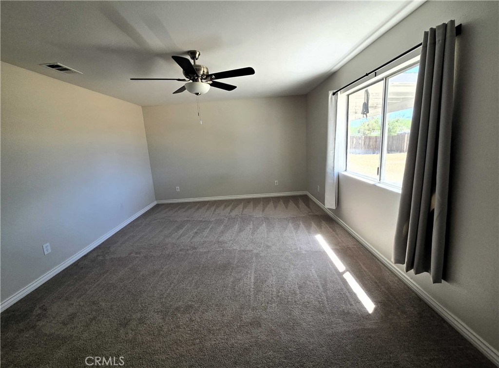 22909 Eyota Road Apple Valley, CA 92308 - Photo 7 of 18 an empty room with a window
