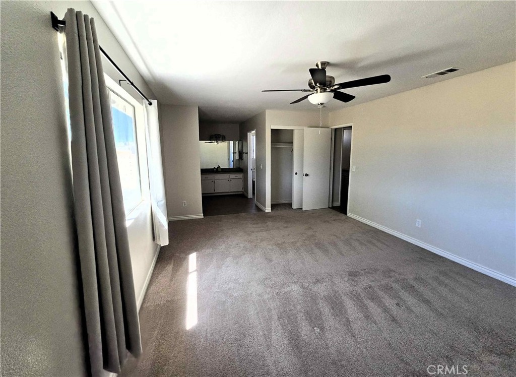 22909 Eyota Road Apple Valley, CA 92308 - Photo 8 of 18 wooden floor in an empty room with a window