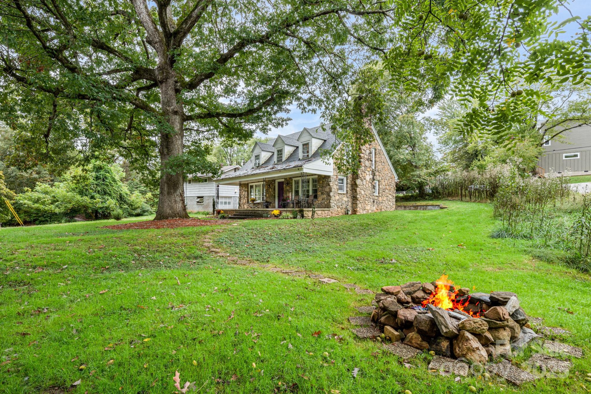 a view of a house with backyard sitting area and garden
