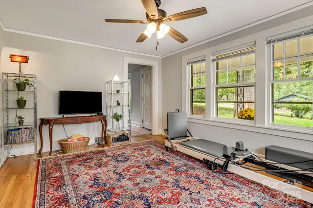 a living room with fireplace furniture and a flat screen tv