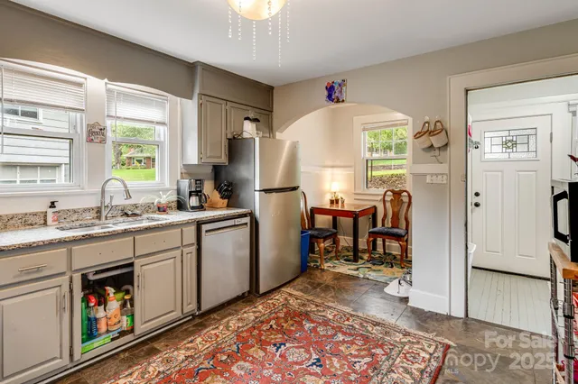 a kitchen with sink cabinets and outdoor dining space