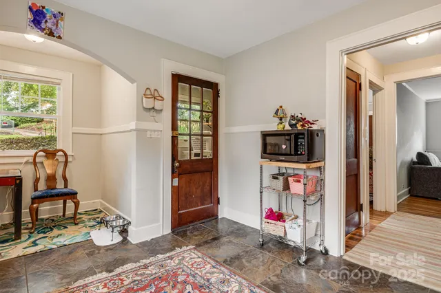 a living room with furniture a flat screen tv and a table