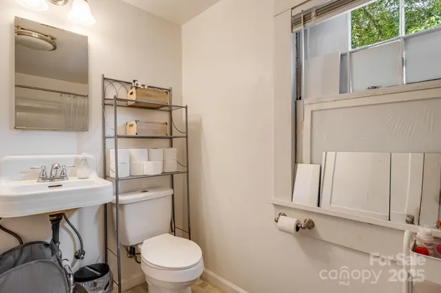 a bathroom with a sink a toilet and mirror