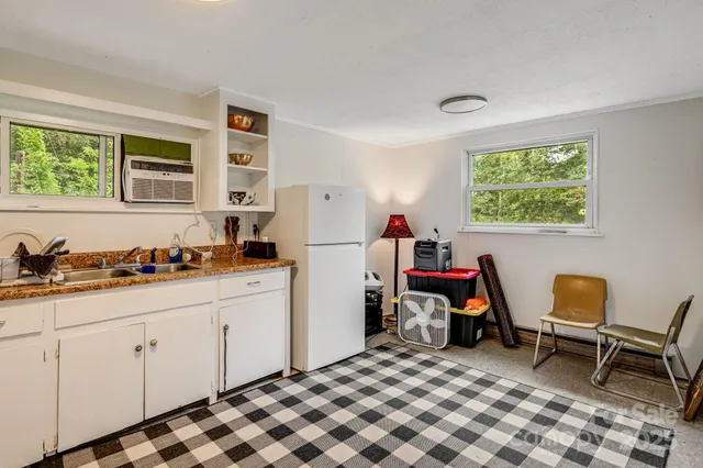 a kitchen that has a sink and chair