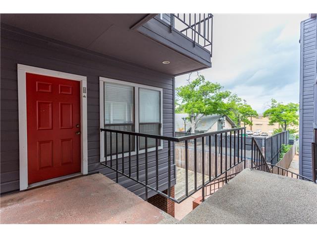 2804 Rio Grande Street, Unit 204 Austin, TX 78705 - Photo 5 of 12 A vibrant red entry door greets you from a covered outdoor walkway.