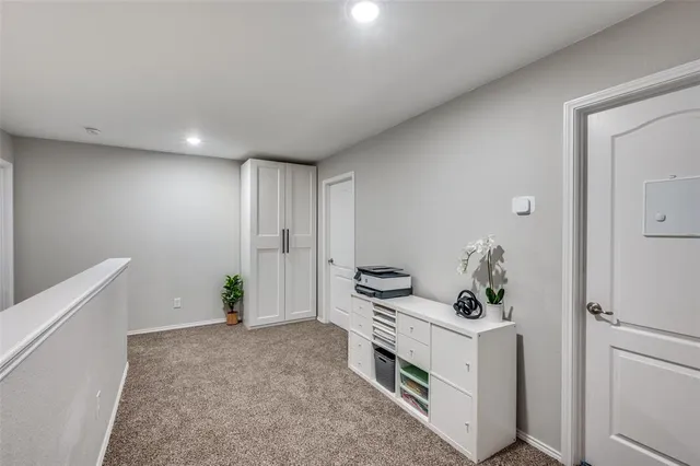 a spacious bedroom with a bed and a chandelier