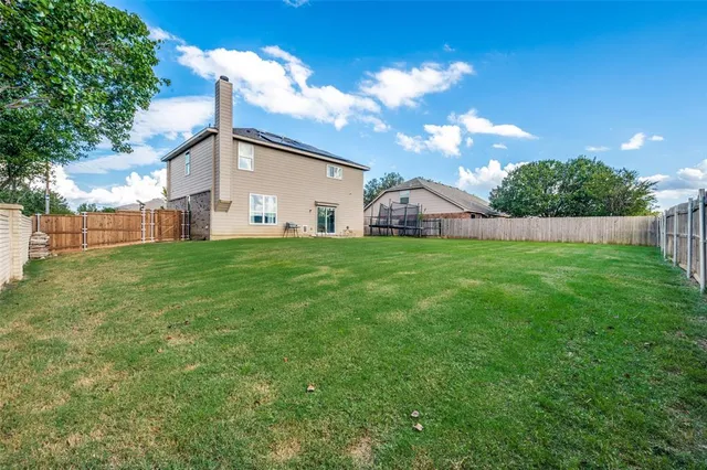 a view of yard with swimming pool and green space