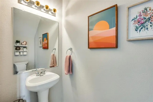 a bathroom with a sink mirror and vanity