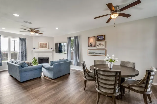 a living room with fireplace furniture and a wooden floor