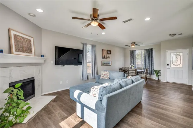 a living room with furniture a flat screen tv and a fireplace
