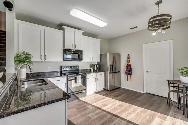 a kitchen with refrigerator and microwave
