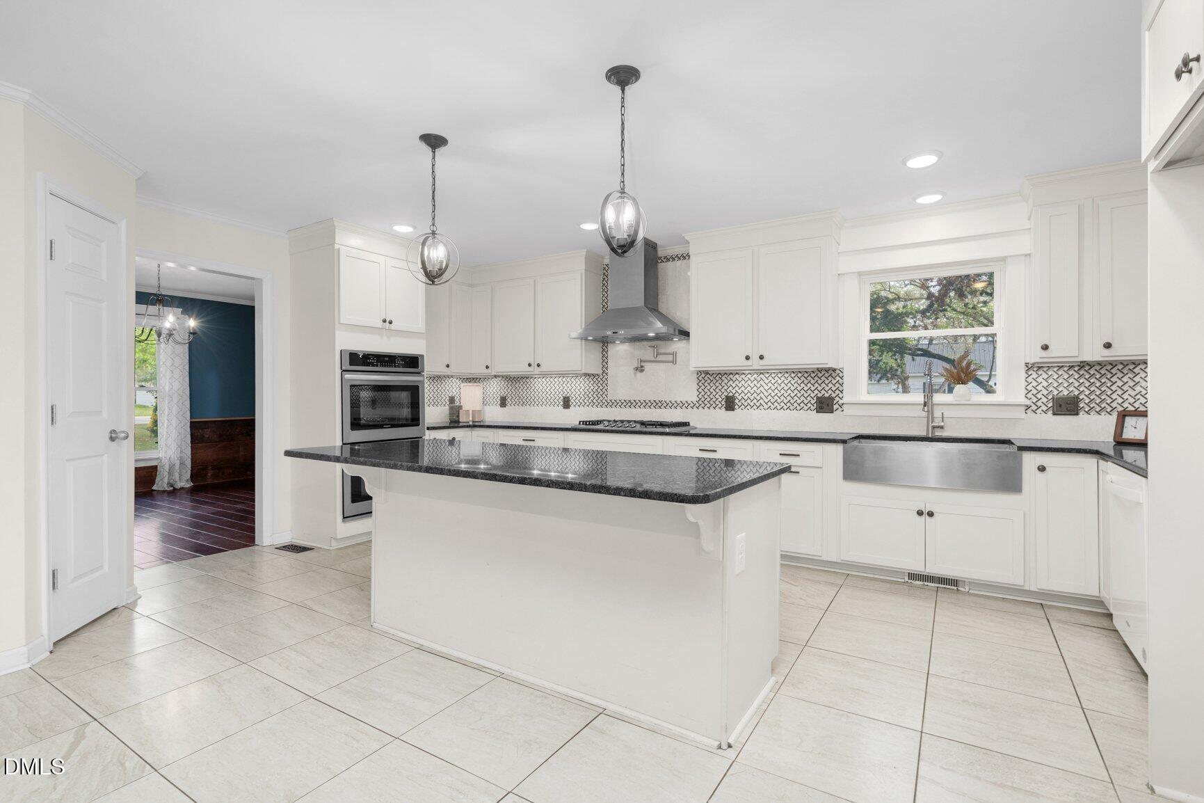 2141 McNair Road Tarboro, NC 27886 - Photo 12 of 55 a kitchen with stainless steel appliances granite countertop a sink and cabinets