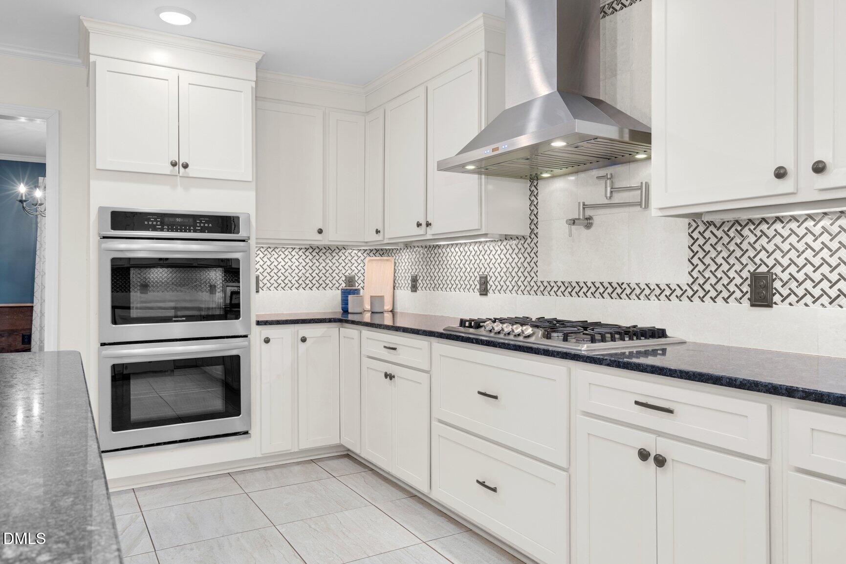 2141 McNair Road Tarboro, NC 27886 - Photo 14 of 55 a kitchen with granite countertop white cabinets and stainless steel appliances