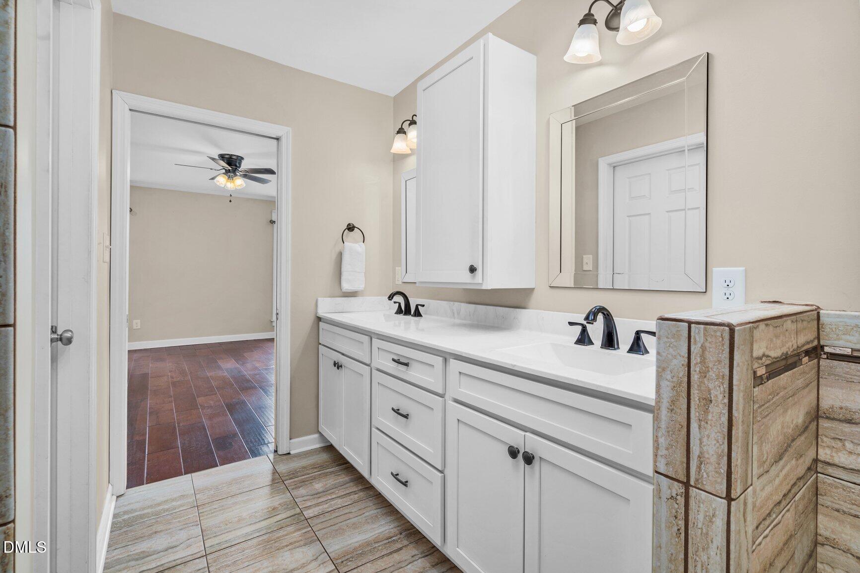2141 McNair Road Tarboro, NC 27886 - Photo 18 of 55 a bathroom with a double vanity sink and mirror