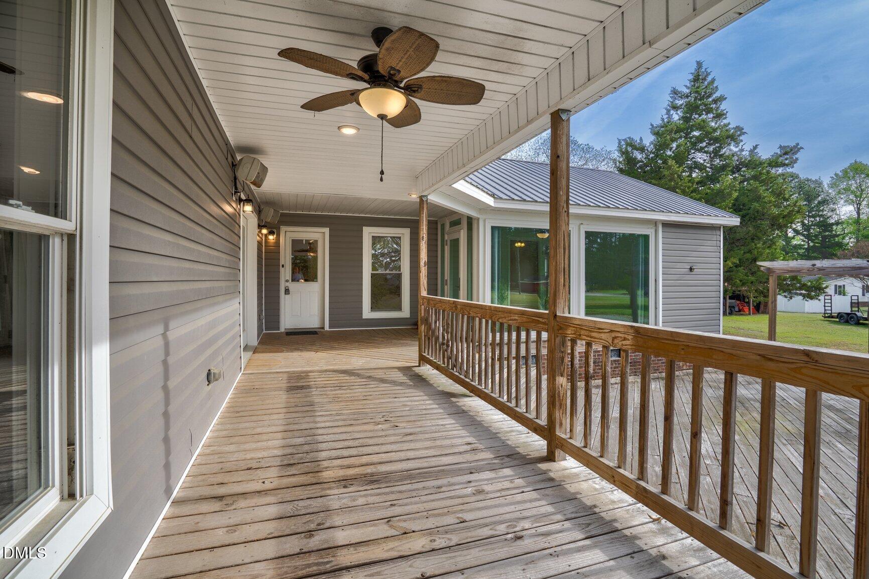 2141 McNair Road Tarboro, NC 27886 - Photo 32 of 55 a view of a balcony with wooden floor and fence and a ceiling fan