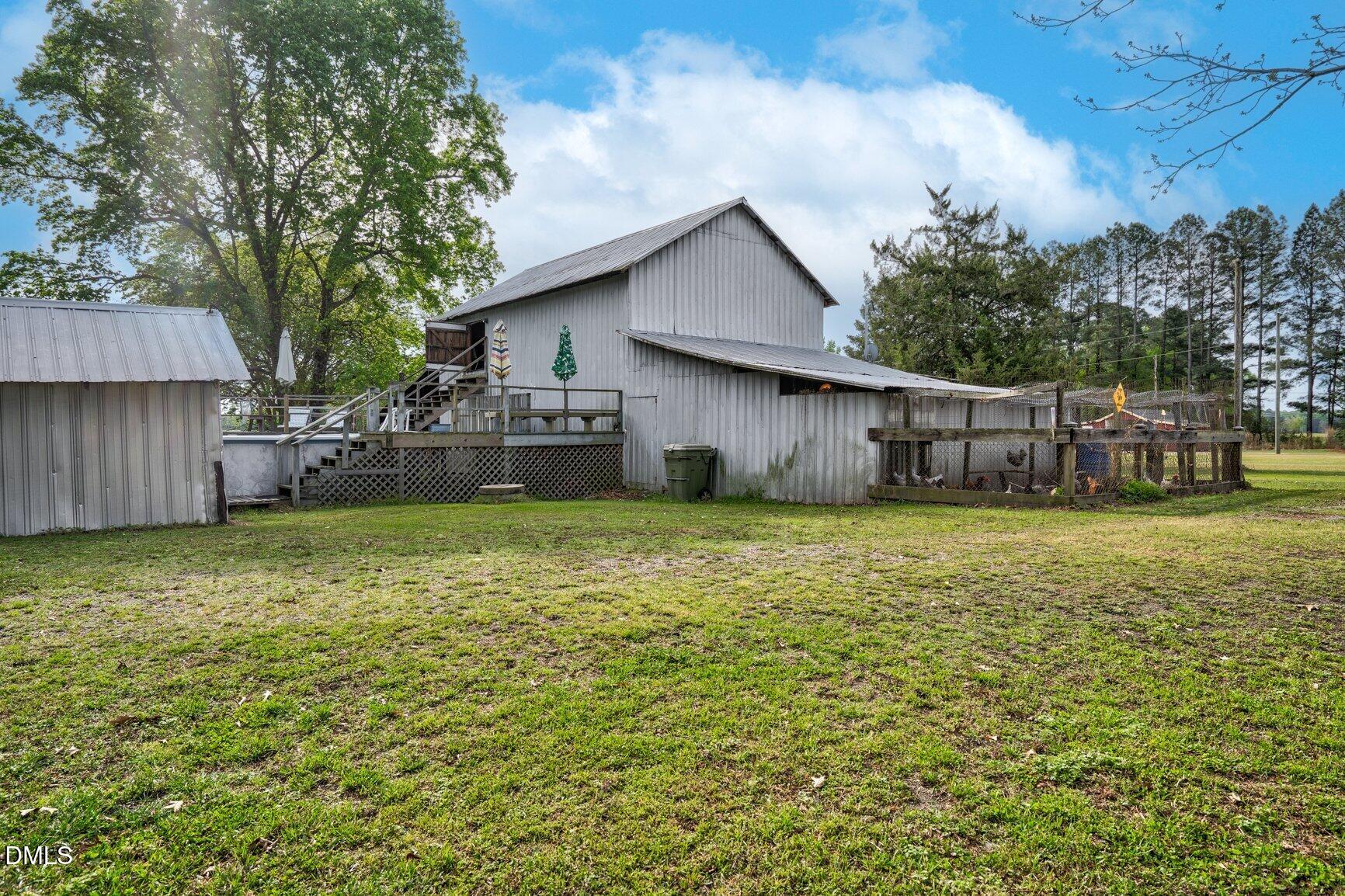 2141 McNair Road Tarboro, NC 27886 - Photo 45 of 55 a backyard of a house with a garden and barbeque oven