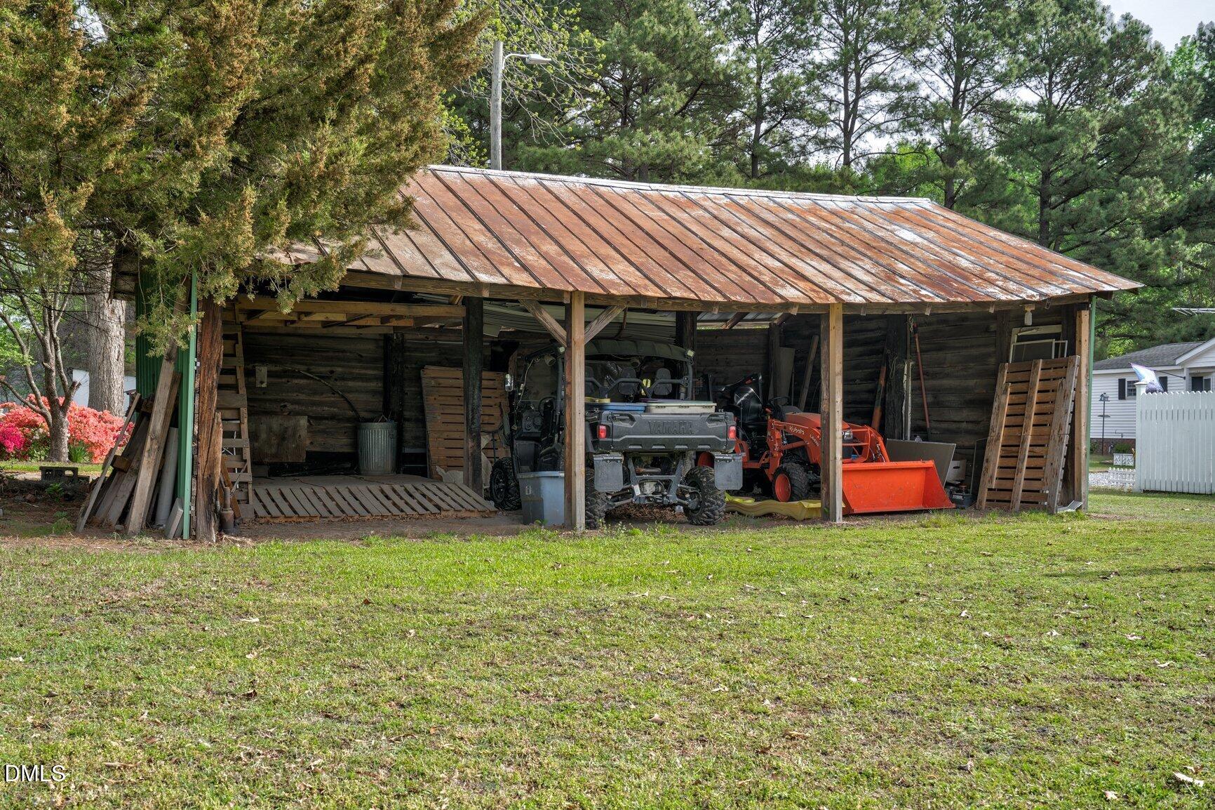 2141 McNair Road Tarboro, NC 27886 - Photo 46 of 55 a view of a patio with table and chairs under an umbrella