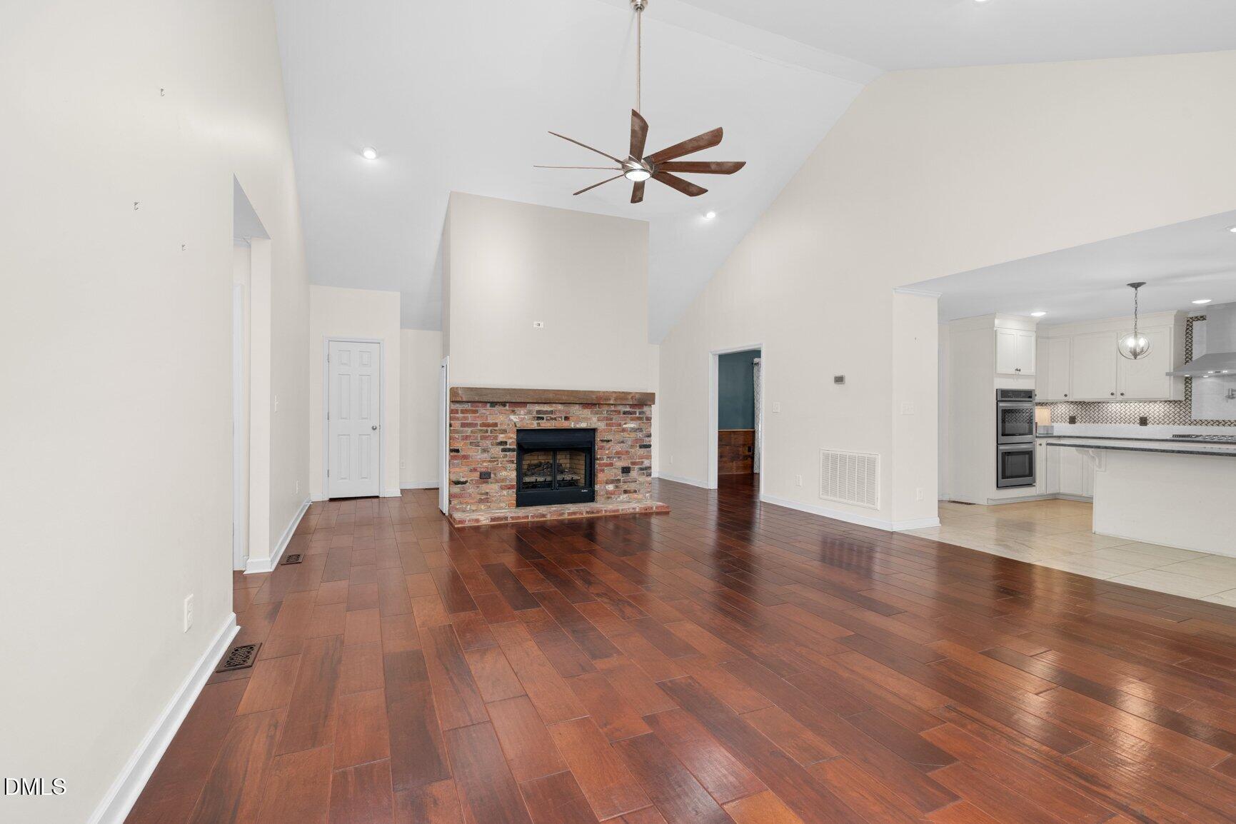 2141 McNair Road Tarboro, NC 27886 - Photo 6 of 55 a view of empty room with wooden floor and fireplace