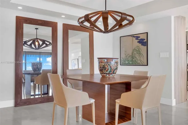 a view of a dining room with furniture chandelier and wooden floor