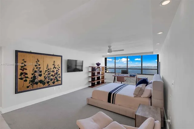 a bed room with furniture and a large window