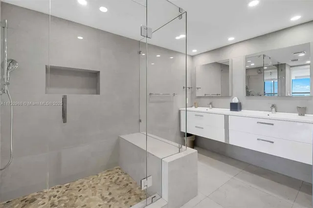 a large white bathroom with a sink a vanity and a mirror