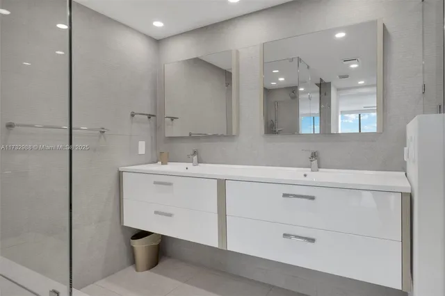 a bathroom with a sink double vanity and a shower