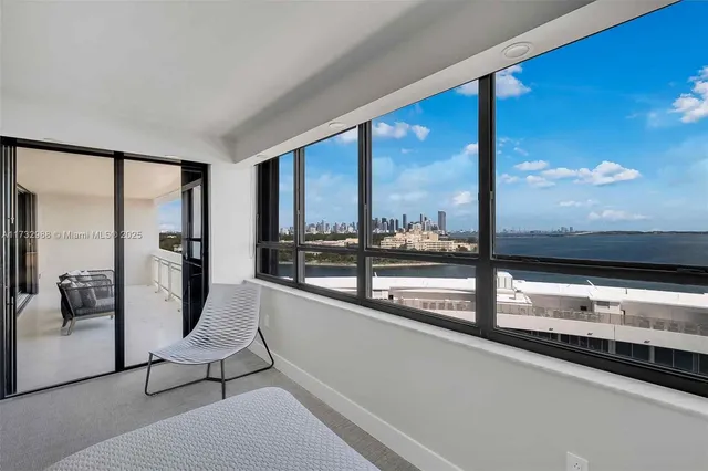 a view of a floor to ceiling window with kitchen view