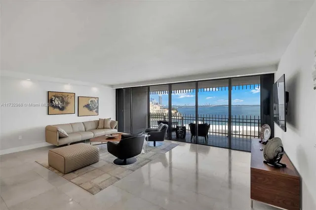 a living room with furniture large window and flat screen tv