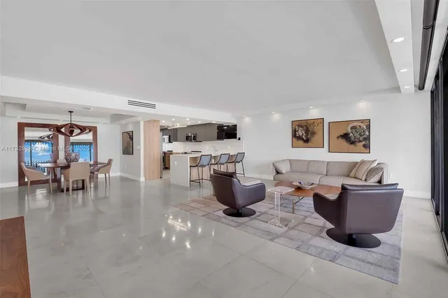 a living room with furniture and view of kitchen