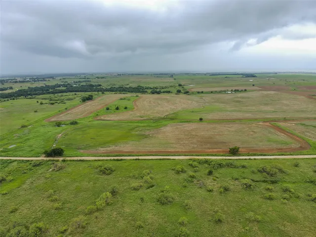 a view of a field with an ocean
