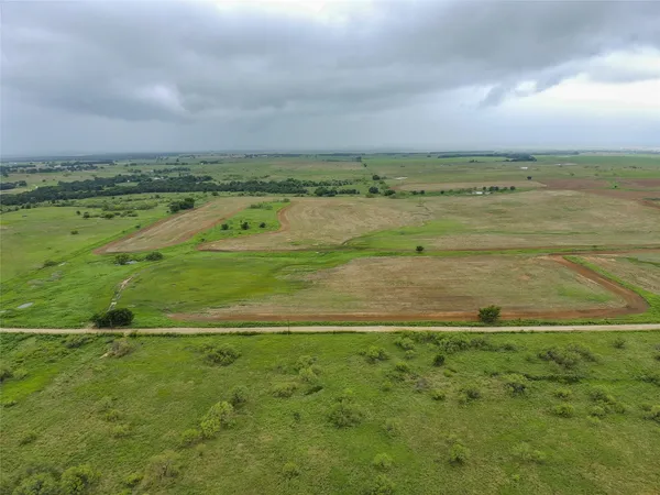a view of a field with an ocean
