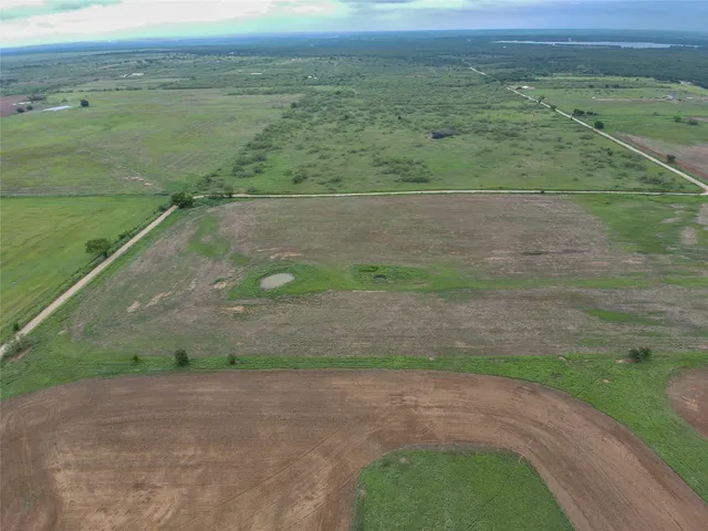 a view of a field with an ocean view