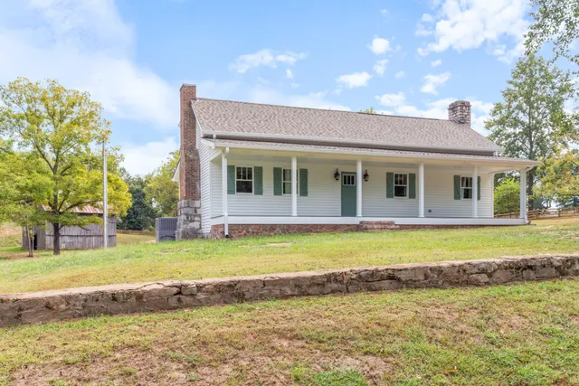 a view of a house with a swimming pool and a yard